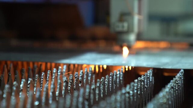 Close Up Shot Of An Automated CNC Machine Precision Cutting Steel Plate During Fabrication Process.