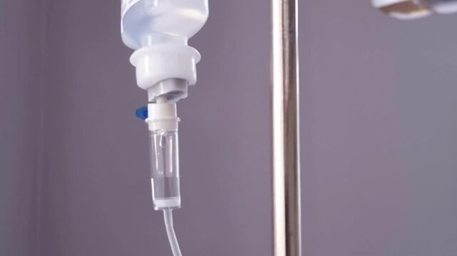 iv drip drops into the patient's room Closeup Saline solution or NSS fluid from IV bag NSS iv dripping tube infusion pumping in hospital chemotherapy