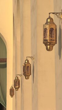 Vertical Close Up of Traditional Arabic Brass Lanterns on Mosque Wall