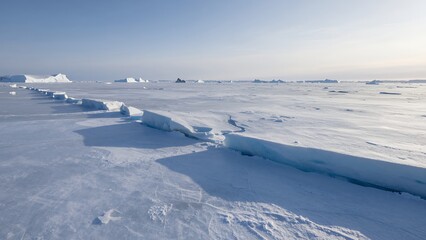 Frozen Arctic Landscape with Ice and Snow under a Clear Sky, Wide View of Polar Region