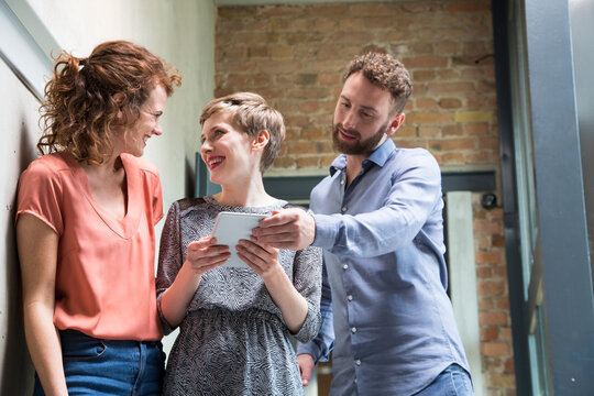 Colleagues sharing tablet