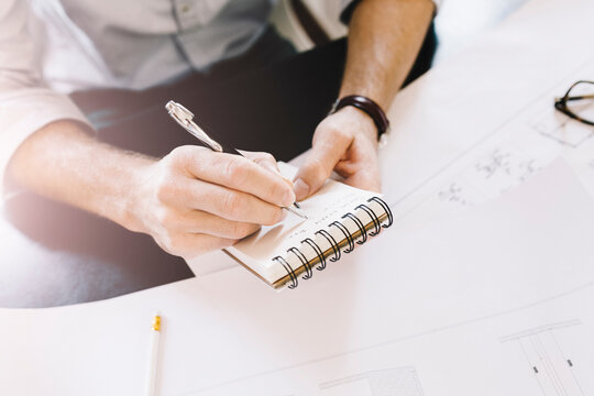 Architect taking notes at desk