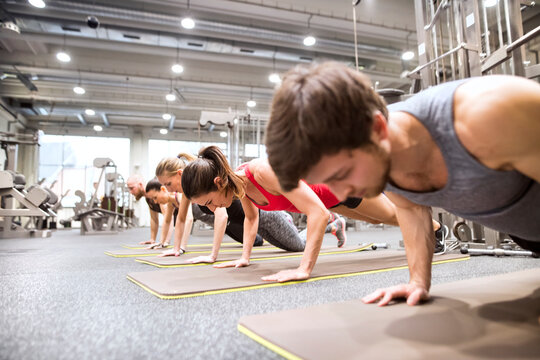 Group of athletes exercising in gym