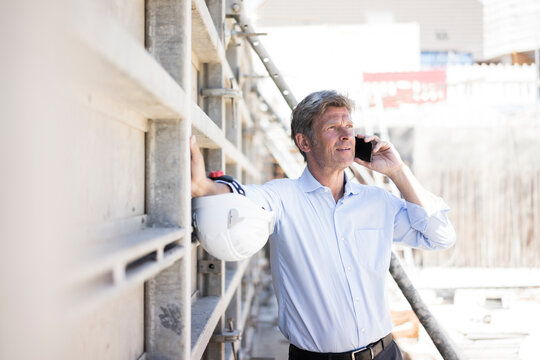 Man on cell phone on construction site