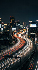 Fototapeta premium Night highway light trails with highway light trails and city traffic on urban expressway for night bokeh and long exposure plates