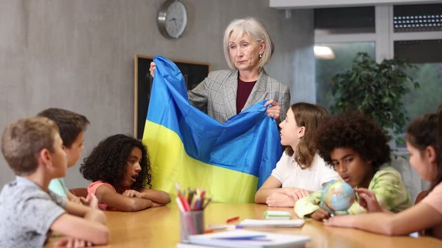 curious students listen attentively to the teacher who tells interesting facts about Ukraine
