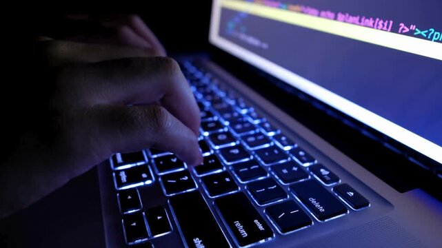 adult programmer coding to develop a program at his office table during work hours. Focus on Hands computer keyboard. Silhouette. Using Internet, 4K