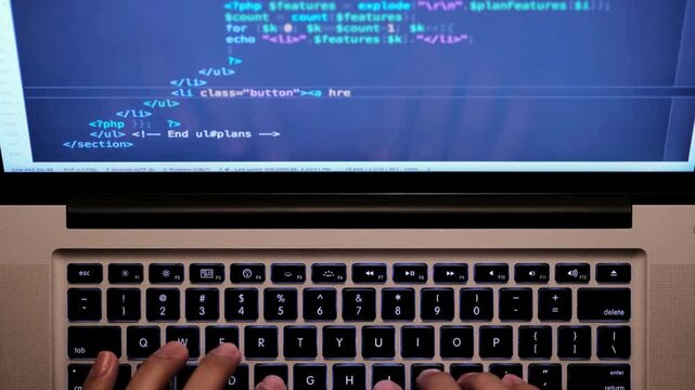 Male hands writing program codes on his computer screen close-up. programmers coding laptop in office Remote work arrangements. Web application design