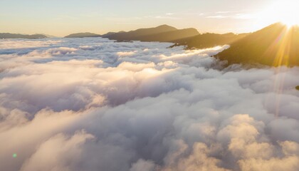 Obraz premium A breathtaking sunrise over mountains with a sea of clouds filling the valley, creating a serene and majestic natural landscape.