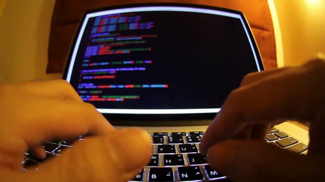 Hands Coding on Laptop, Man's Hands Coding on Laptop CLOSE UP anonymous man sitting at desk late at night, Rear view male coding on laptop screen.