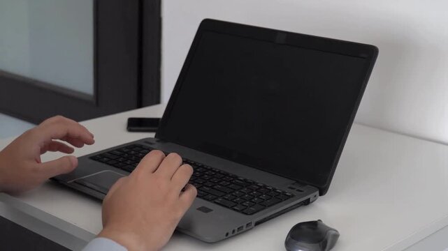 Close up of monitor screen with developing Businessman or IT programmer uses a computer while sitting at a desk at a workplace in a business office.