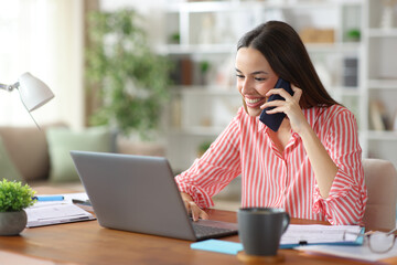 Happy self employed working attending phone call