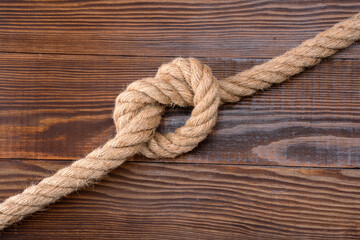 Fototapeta premium Thick rope on wooden background