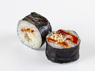 Unagi maki sushi rolls with teriyaki sauce and sesame seeds isolated on white background © Andrei Starostin