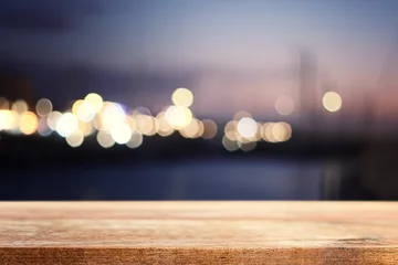 Wooden table and lights during night time. Product display or mockup © tomertu