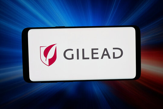 Stuttgart, Germany - 03-13-2026: In this photo illustration, the logo of US biopharma company Gilead Sciences Inc. is displayed on a smartphone in front of abstract background on computer screen.