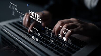 Advanced Technology for Hotel Management with Digital Interface and Hands Typing on Laptop Keyboard in Dark Setting Quark.