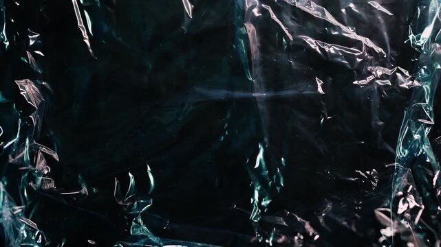 Mysterious Glossy Black Crumpled Texture with Moving Light Reflections