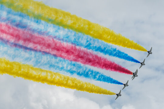 Aerial view of vibrant colored smoke trails painting the sky above Changi Exhibition Centre with airplanes gracefully soaring, Changi Exhibition Centre, Singapore Air Show 2026, Singapore.