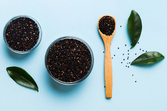 quinoa seeds in bowl and spoon on colored background. Healthy kinwa in small bowl. Healthy superfood