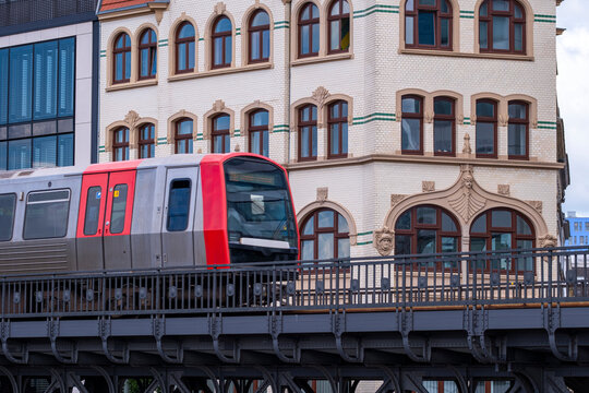 Urban mobility view of an elevated metro train on railway above cityscape in Hamburg Germany highlighting transport movement and modern infrastructure