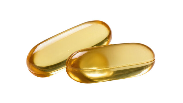 Isolated two translucent golden softgel capsules, commonly containing vitamins or supplements