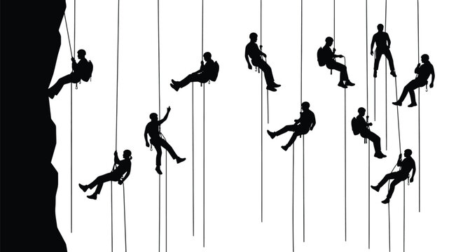 Silhouettes of multiple climbers rappelling down a steep rocky cliff face with safety equipment
