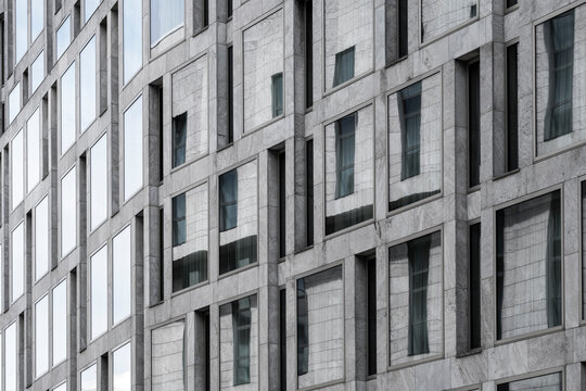 Repeating window grid on modern urban building facade with abstract architectural pattern creating a clean corporate background and texture