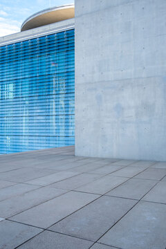 Open modern plaza scene with urban architecture in concrete and glass featuring minimal abstract composition and generous space as background