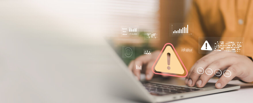 Cyber security warning alert on laptop screen with businessman typing on computer, digital risk monitoring, data breach protection, system error notification and technology safety concept for business