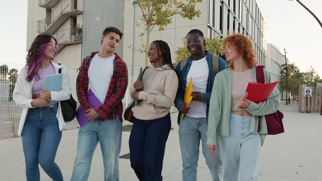 Diverse group of university students walking on campus together