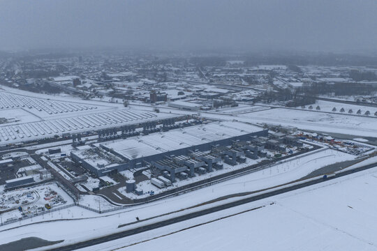 Aerial view of data center with its solar panel field, covered by snow, modern infrastructure in a winter landscape, Winschoten, Netherlands