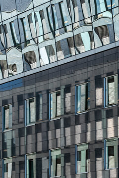 Abstract modern architecture facade where windows repeat a pattern and geometry meets texture as lines follow gentle curvature across surface