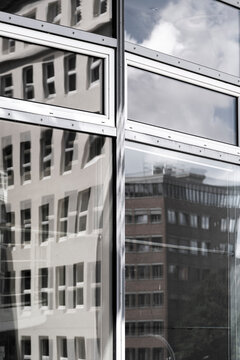 Architecture glass reflections on corporate facade as modern windows form a repeating grid pattern seen in dramatic perspective study