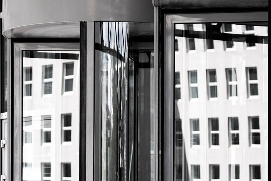 Modern corporate architecture facade with glass windows reflections and symmetry in monochrome frame forming abstract grid pattern
