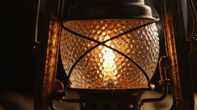 Video lantern flame flicker with cozy warm motion on dark background, atmospheric lighting concept for relaxation media, meditation visuals, rustic branding, and ambient digital backdrops.
