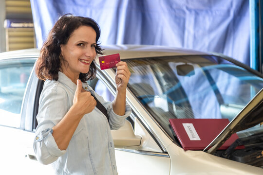 Auto repair shop, small business, garage, technology, mechanic or garage owner presents credit card for cashless payment, confirms repair bill, customer transaction, modern car insurance services