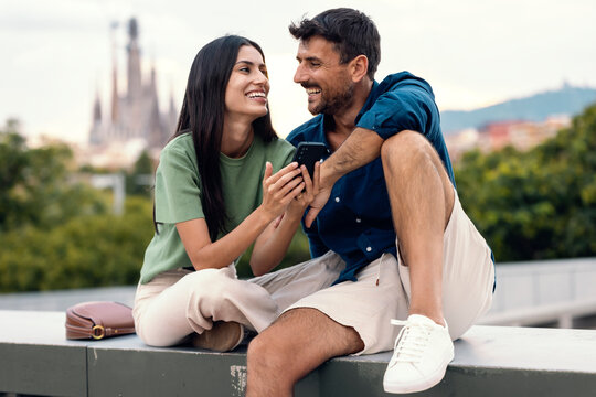 Happy couple enjoying time together in front of iconic city architecture