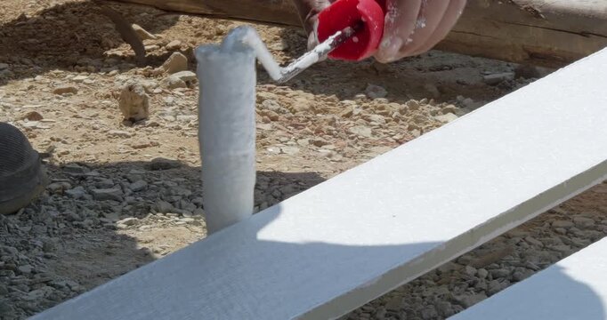 A detailed view of someone painting wooden planks for a DIY project.