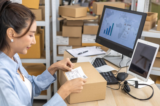 Ecommerce, packing, shipping, fulfillment, multitasking small business owner packing products in home-based warehouse, entrepreneur sealing cardboard box with tape preparing shipment, online store