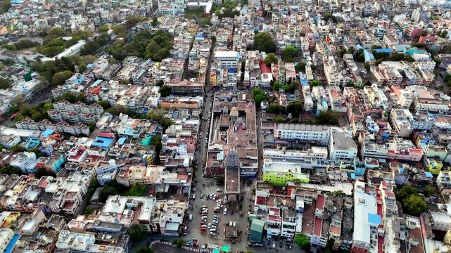 Aerial view of Triplicane neighborhood in Chennai, highlighting the historic Parthasarathy Temple tank surrounded by dense residential buildings, busy streets, and traditional urban blocks near Marina