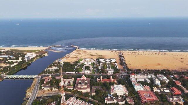 Aerial perspective of the MGR Memorial and Marina Beach Road, capturing the iconic memorial architecture, public gathering spaces, and city traffic moving along the famous Chennai coastline.