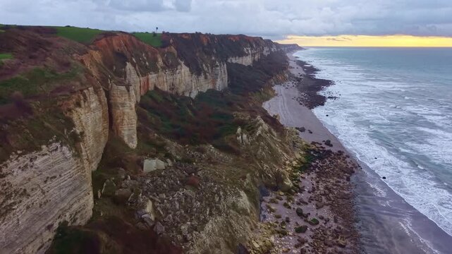 Drone flying along the coastline, cliffs , on the Alabaster coast, Saint-Jouin-Bruneval beach, Normandy in France. Aerial ascending forward