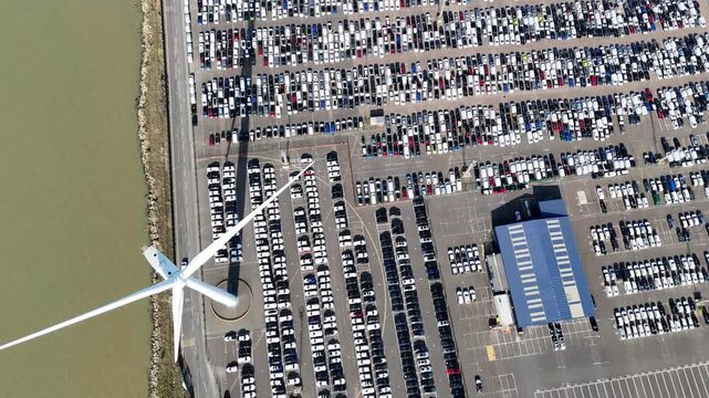 Bird&rsquo;s Eye Drone View of New Cars Parked by Wind Turbine, Isle of Sheppey, UK