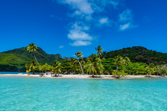 Terei'a Beach with white sand and palm trees in Maupiti French Polynesia