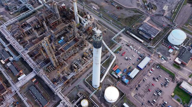 Aerial view of the sprawling Lindsey Oil Refinery, a complex network of pipes and industrial structures against a muted landscape, Immingham, United Kingdom.