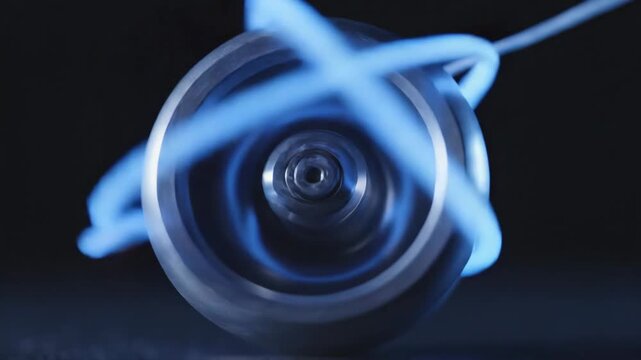 Video of spinning yo-yo performing complex loop trick with illuminated string curves in a black background environment, contemporary motion study for practice, discipline, and coordination