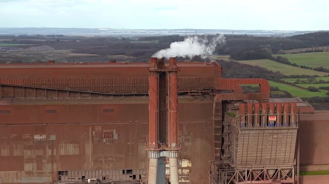 Aerial view of the industrial landscape of Scunthorpe Steel Works, a textured tableau of rust-colored buildings and smokestacks, Scunthorpe, Scunthorpe, United Kingdom.