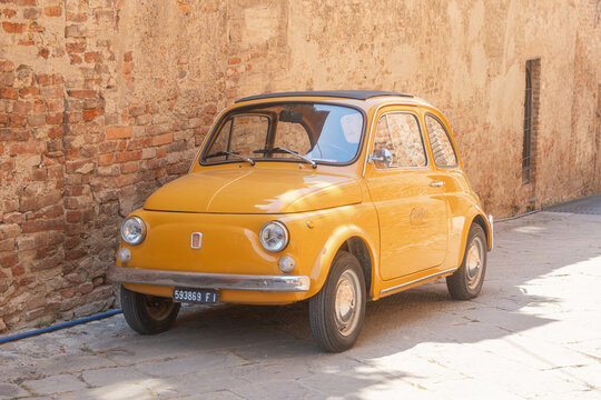 Baccoleno, Italy, 05.07.2026, Vintage Yellow Car Near Brick Wall
