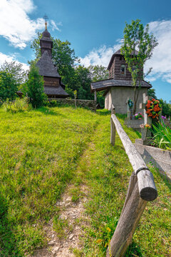 likitsary, transcarpathia, ukraine - 02 jul 2020: traditional wooden church architecture. picture of an old building made from timber in summer landscape under blue sky. religion heritage of ukraine